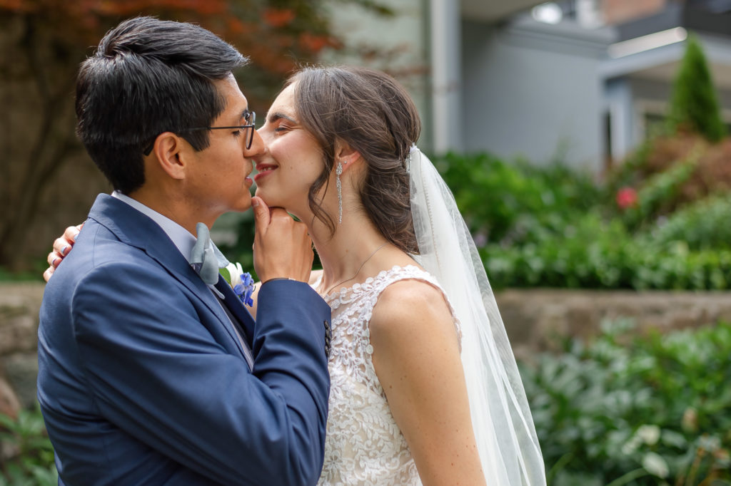 intimate photo of bride and groom kissing on wedding day
