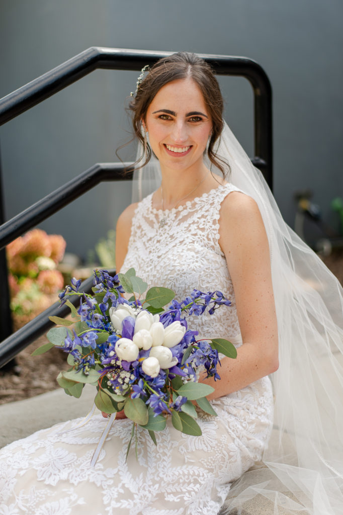 photo of bride posing with her bouquet on her wedding day 