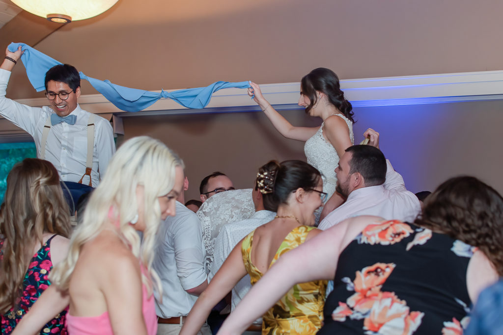 photo of bride and groom in chairs during wedding reception