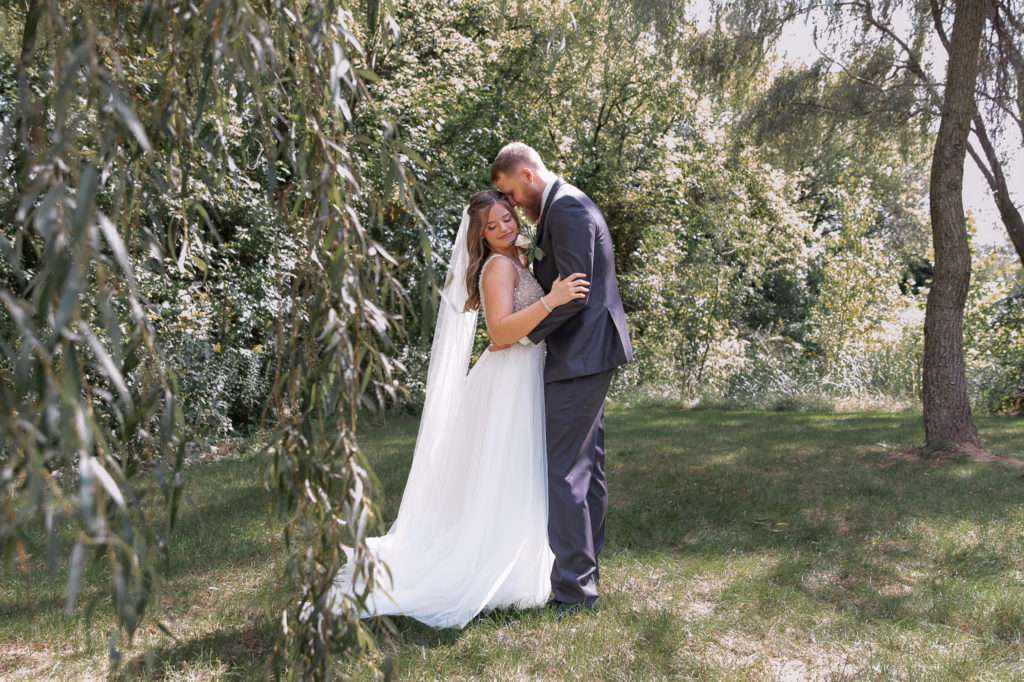 photo of bride and groom posing on their wedding day