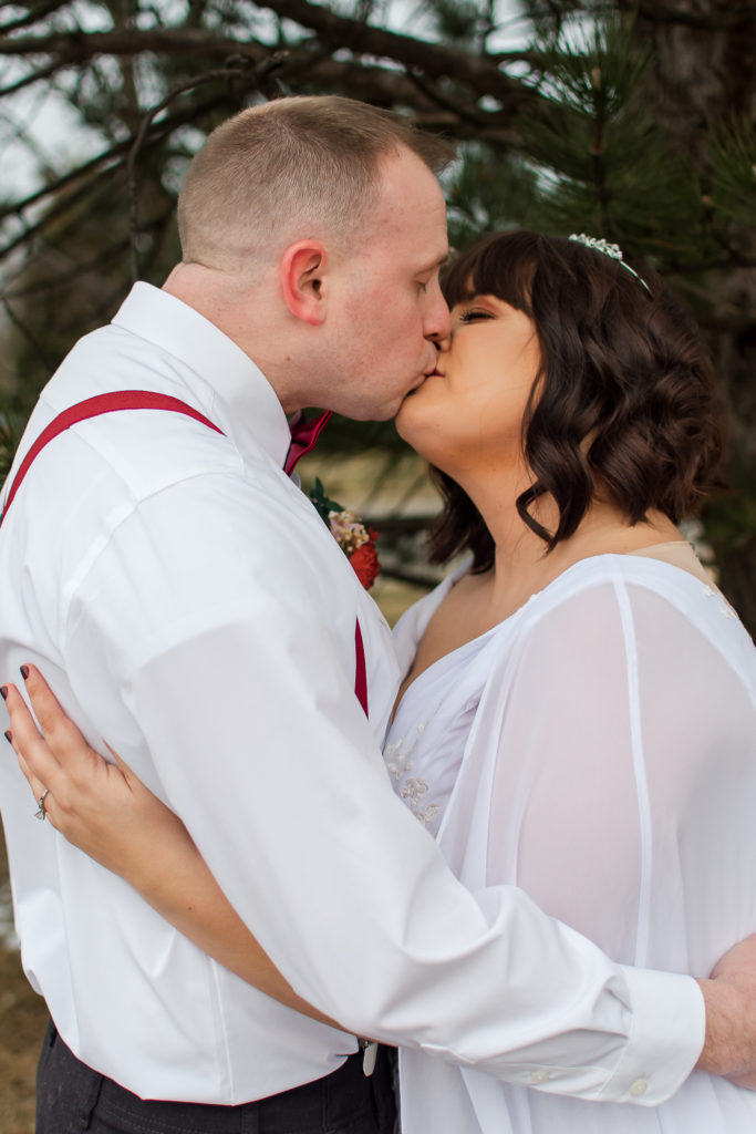 photo of bride and groom kissing during portraits on wedding day