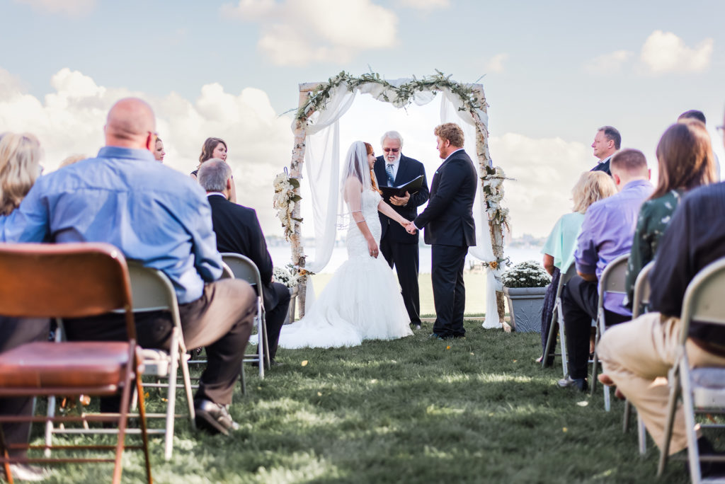 bride and groom holding hands during wedding ceremony