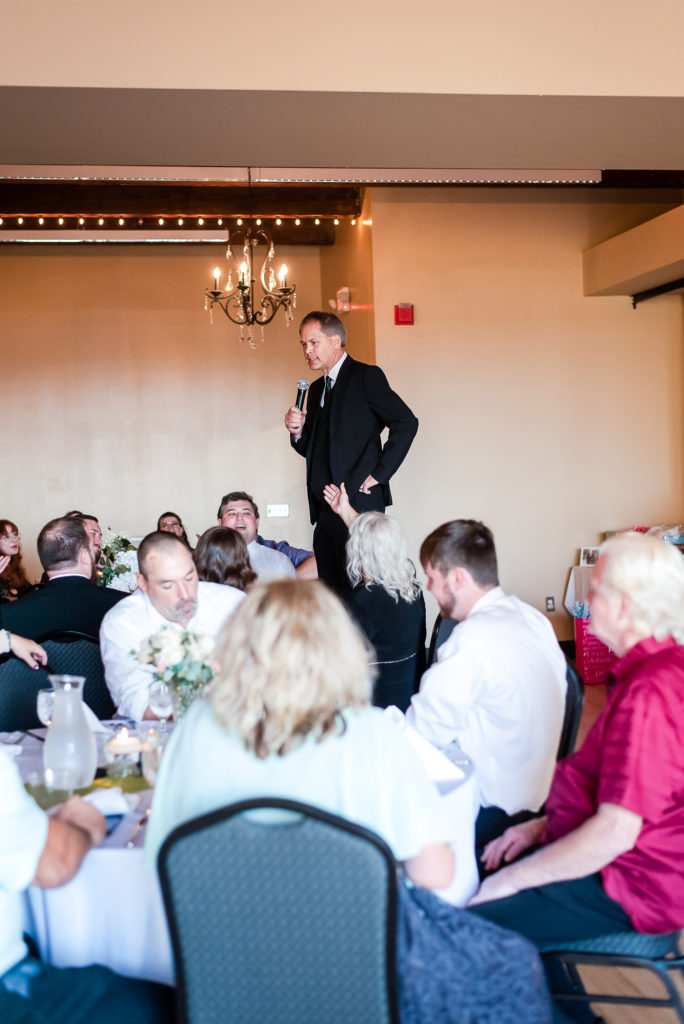 photo of bride's dad standing on table for speech