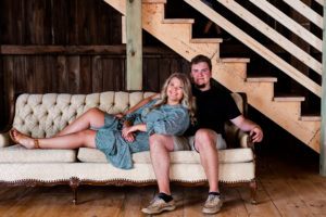 couple snuggling on couch during engagement session