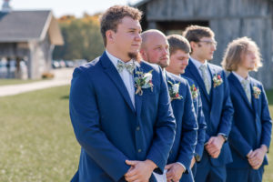 groom posing with his groomsmen during portraits on wedding day