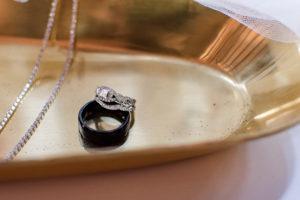 photo of wedding rings on a tray on wedding day