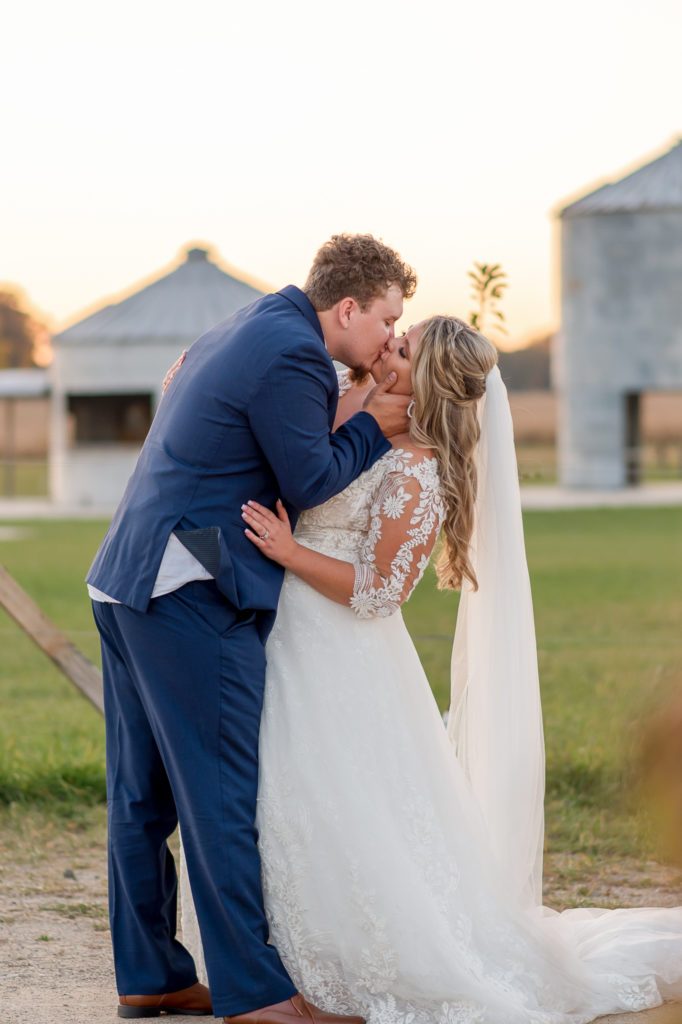 photo of bride kissing groom on wedding day