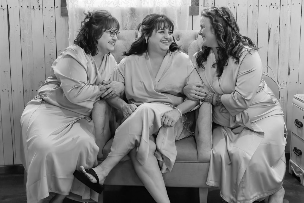 bride relaxing with her bridesmaids before wedding ceremony
