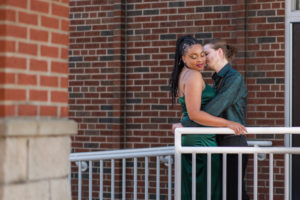 couple snuggling during photo session downtown