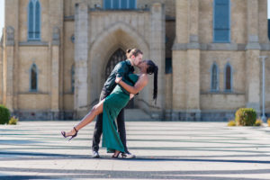 couple dipping and kissing in front of cathedral