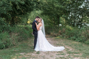 bride and groom posing together during portraits on wedding day