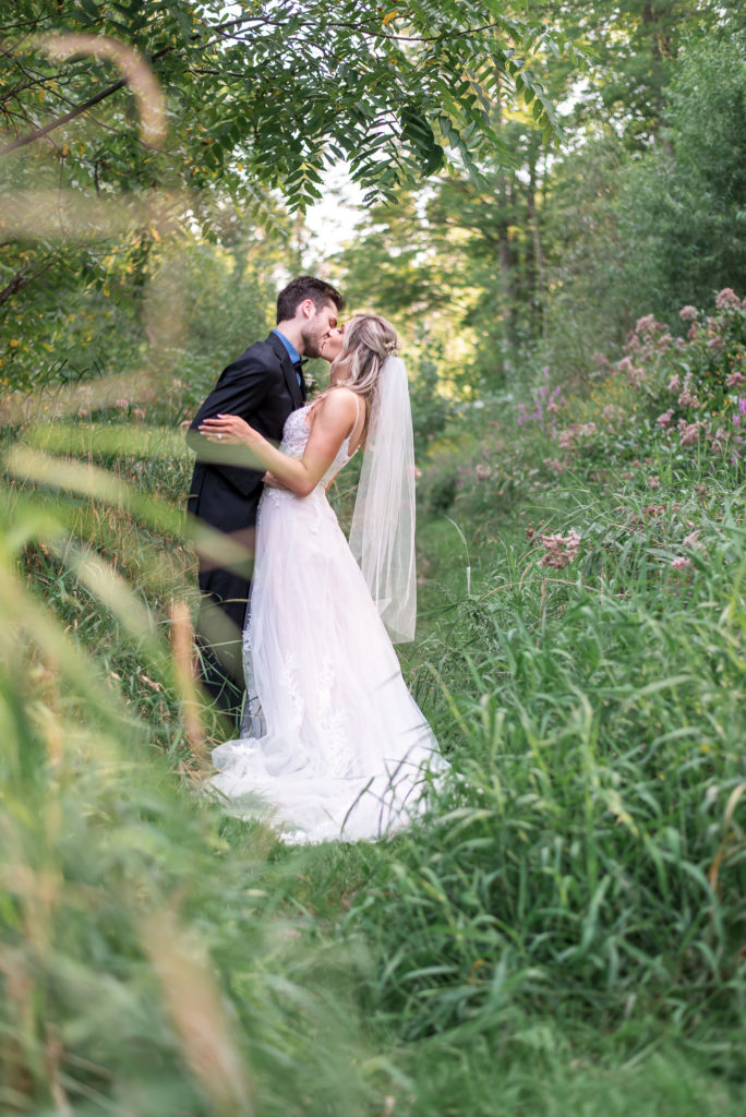 photo of bride and groom kissing during portraits on wedding day