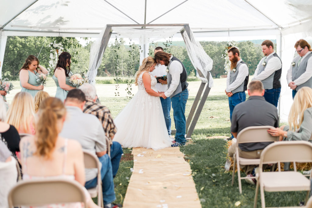 bride and groom praying during wedding ceremony