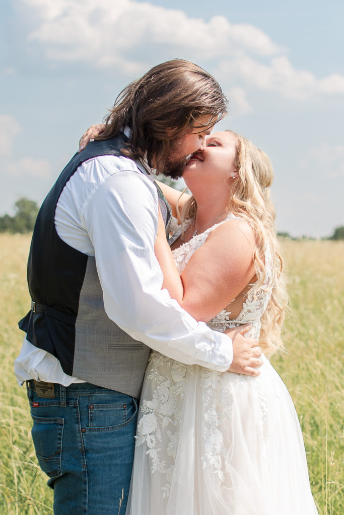 photo of bride and groom kissing on wedding day