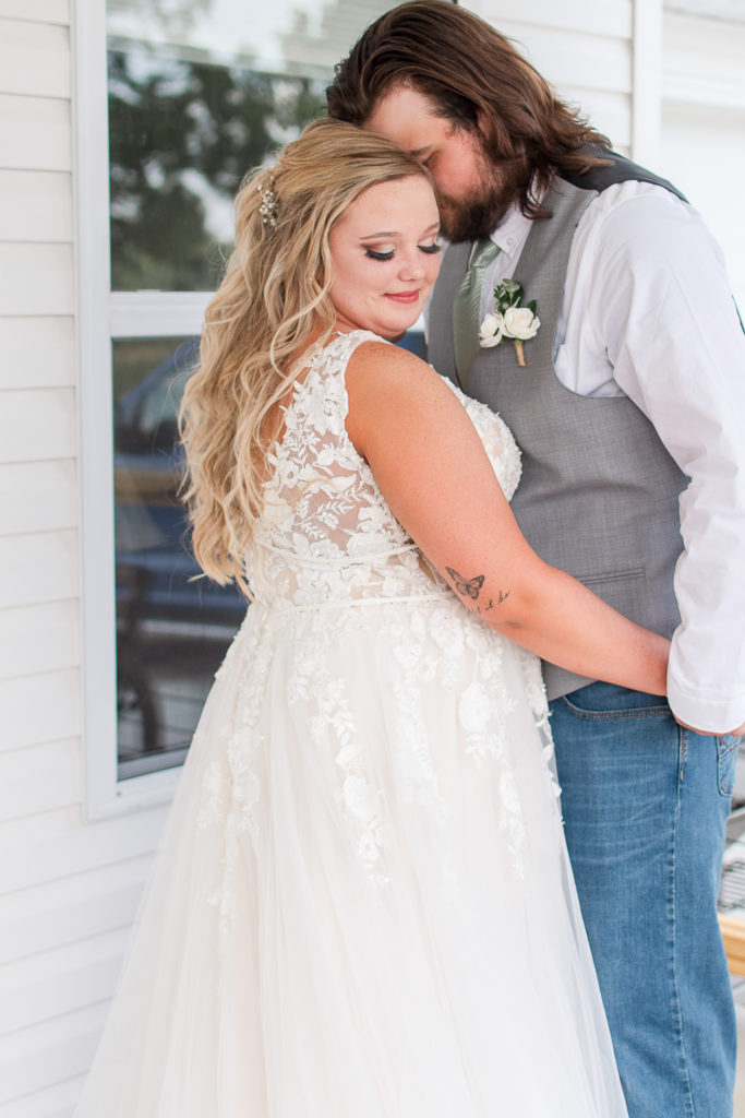 bride and groom snuggling during portraits on wedding day