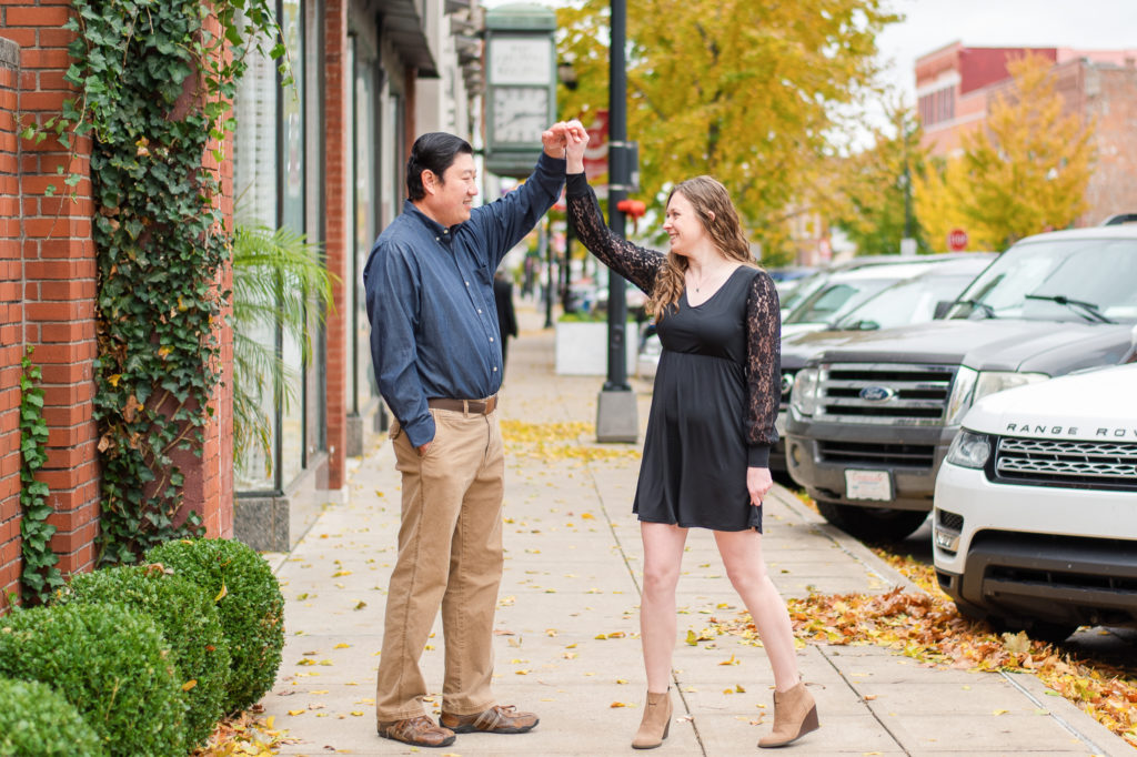 photo of couple twirling on sidewalk in downtown Springfield, MO