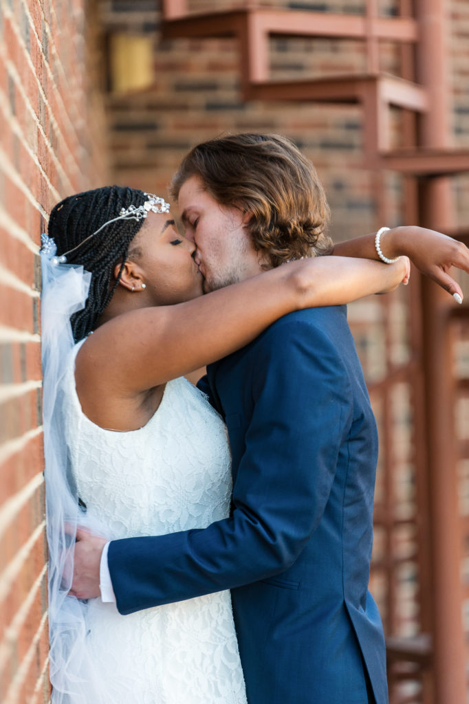 photo of bride and groom kissing on wedding day