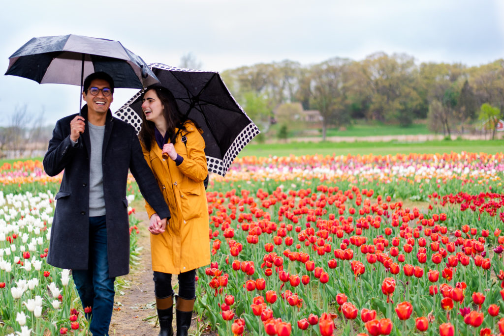 photo of couple laughing and walking during engagement session