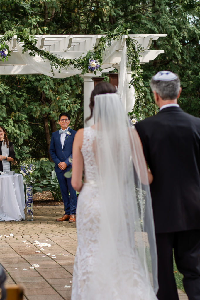 photo of groom's face when he sees bride walking down aisle