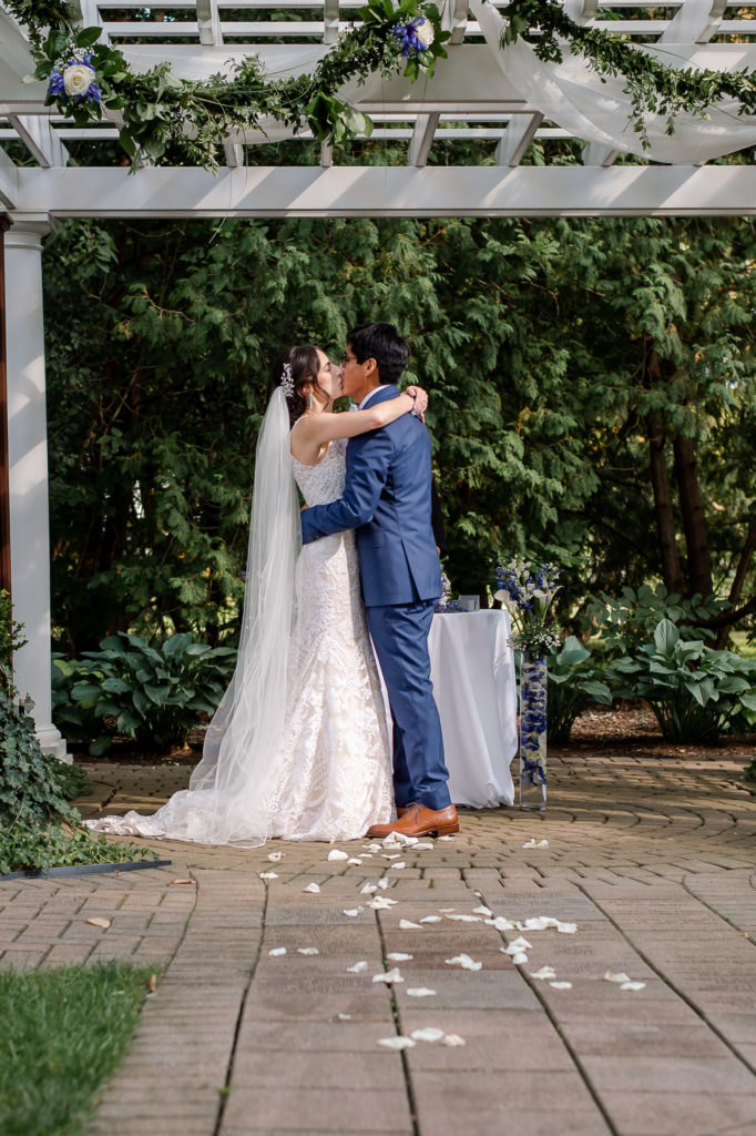 photo of bride and groom's first kiss during wedding ceremony
