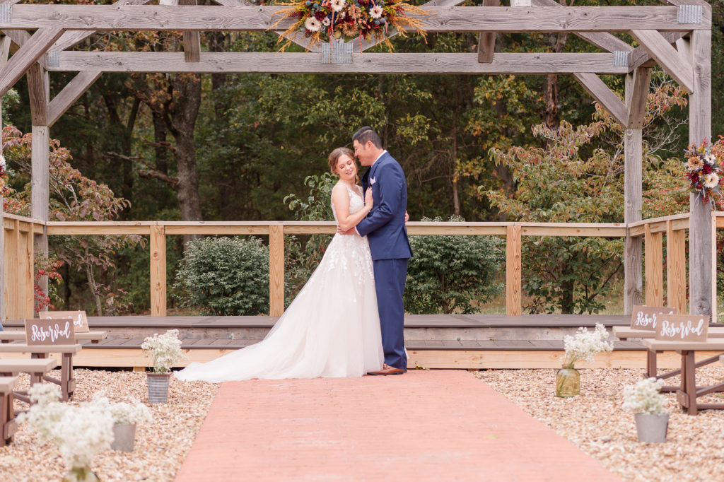 photo of bride and groom posing at their wedding venue