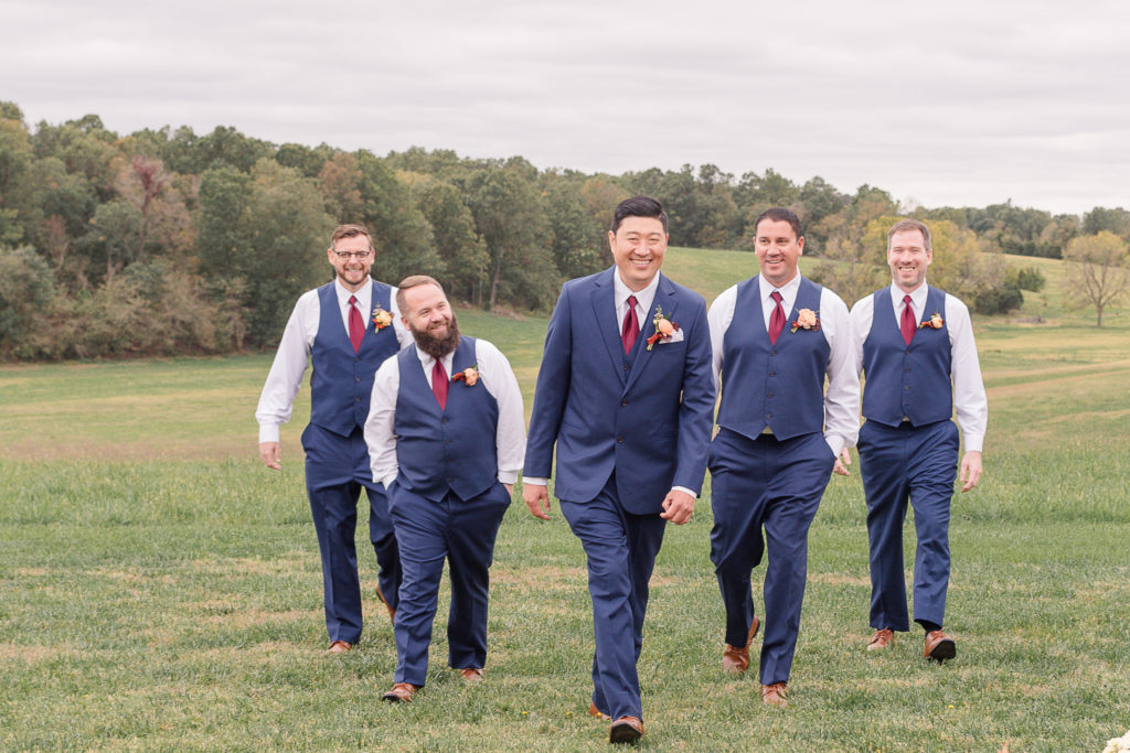 photo of groom walking with groomsmen on wedding day