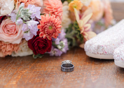 photo of bridal bouquet, rings and shoes