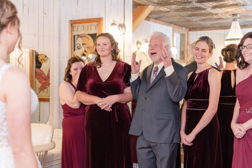 photo of first look of bride with her dad and bridesmaids