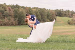 photo of groom dipping and kissing his bride on wedding day