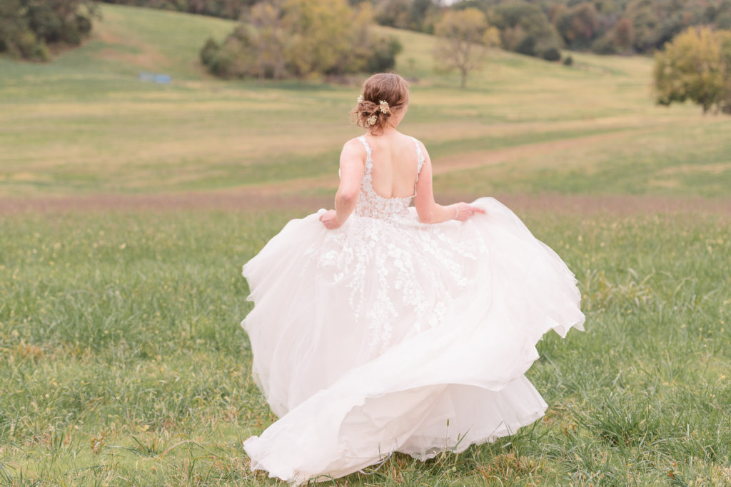 photo of bride twirling her dress on her wedding day