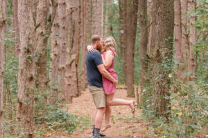 photo of groom lifting bride during woodsy engagement session