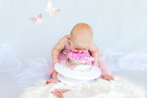 photo of baby eating cake during cake smash session