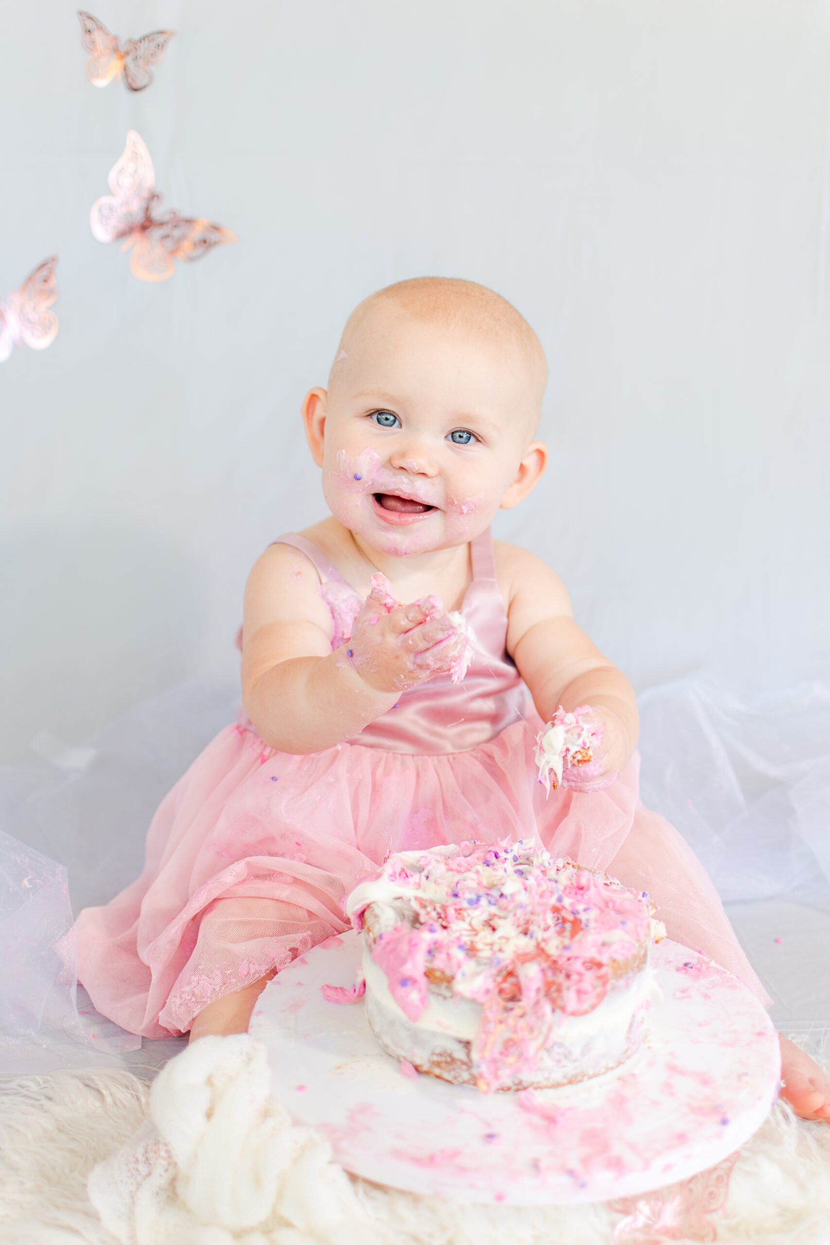 photo of baby smiling during cake smash session