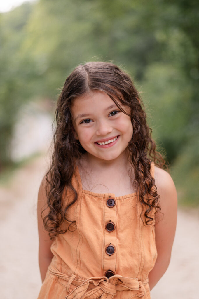 photo of girl smiling at camera in family session