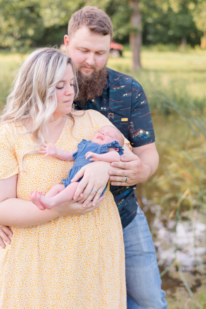 photo of mom and dad holding a newborn during newborn photo session