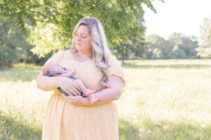 photo of mother holding newborn during newborn photo session