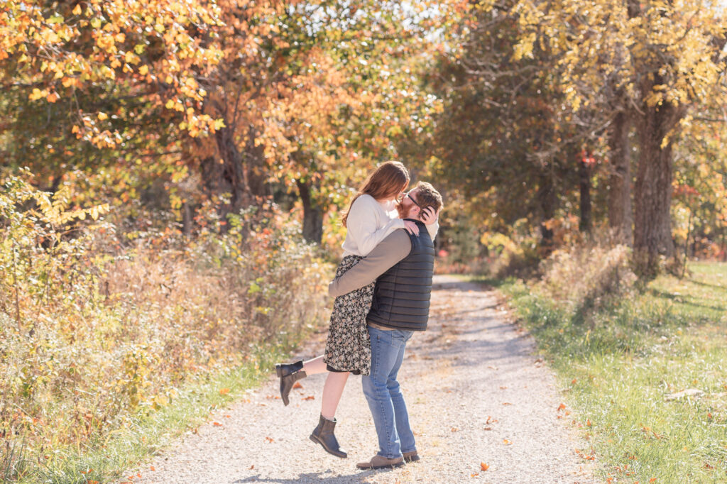 photo of groom picking up bride in engagement session