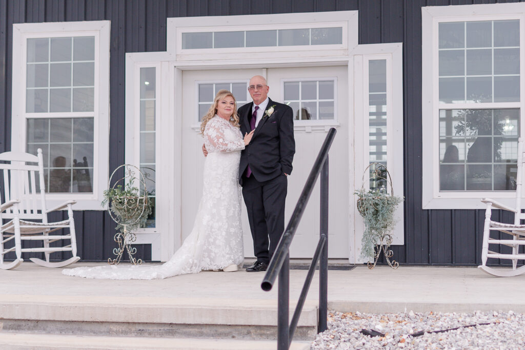 photo of bride and groom smiling at the camera on their wedding day