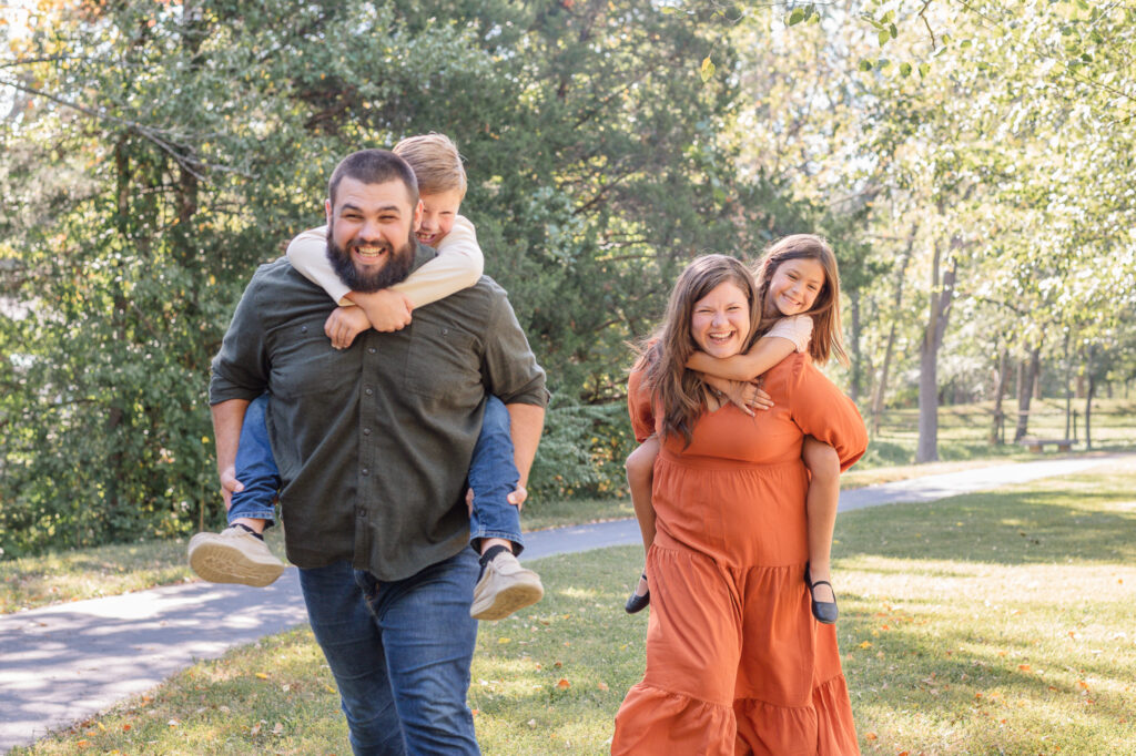 family piggyback racing during family photo session