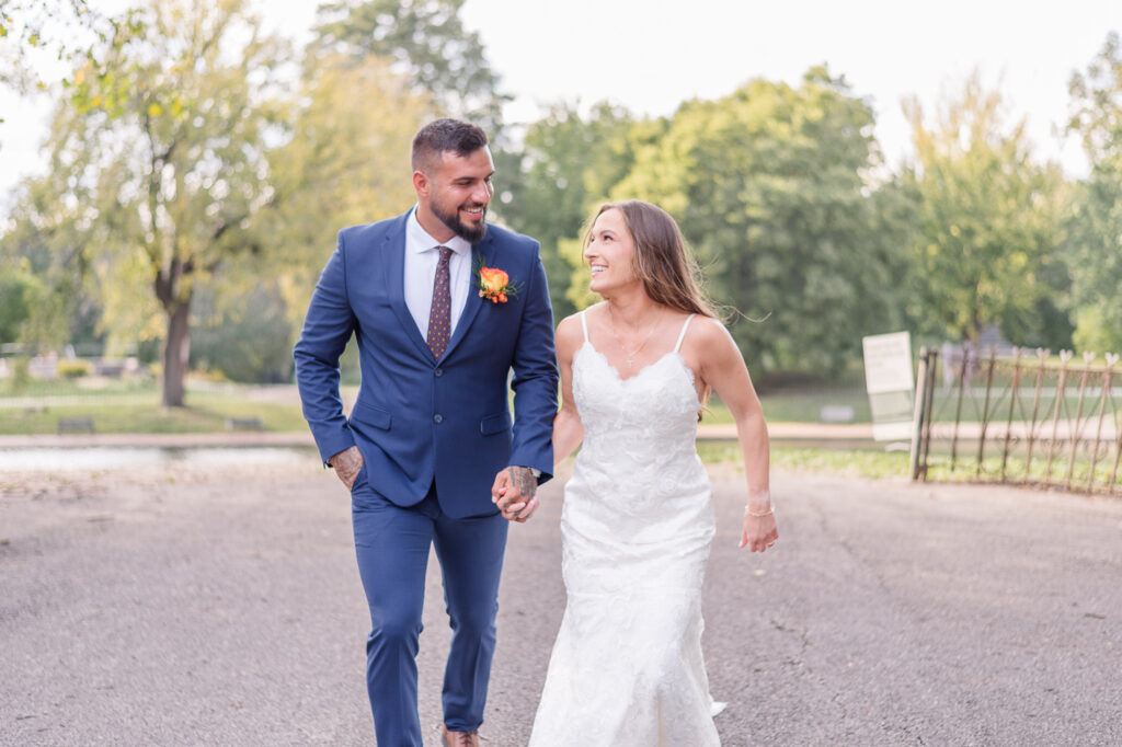 photo of bride and groom holding hands during wedding photos